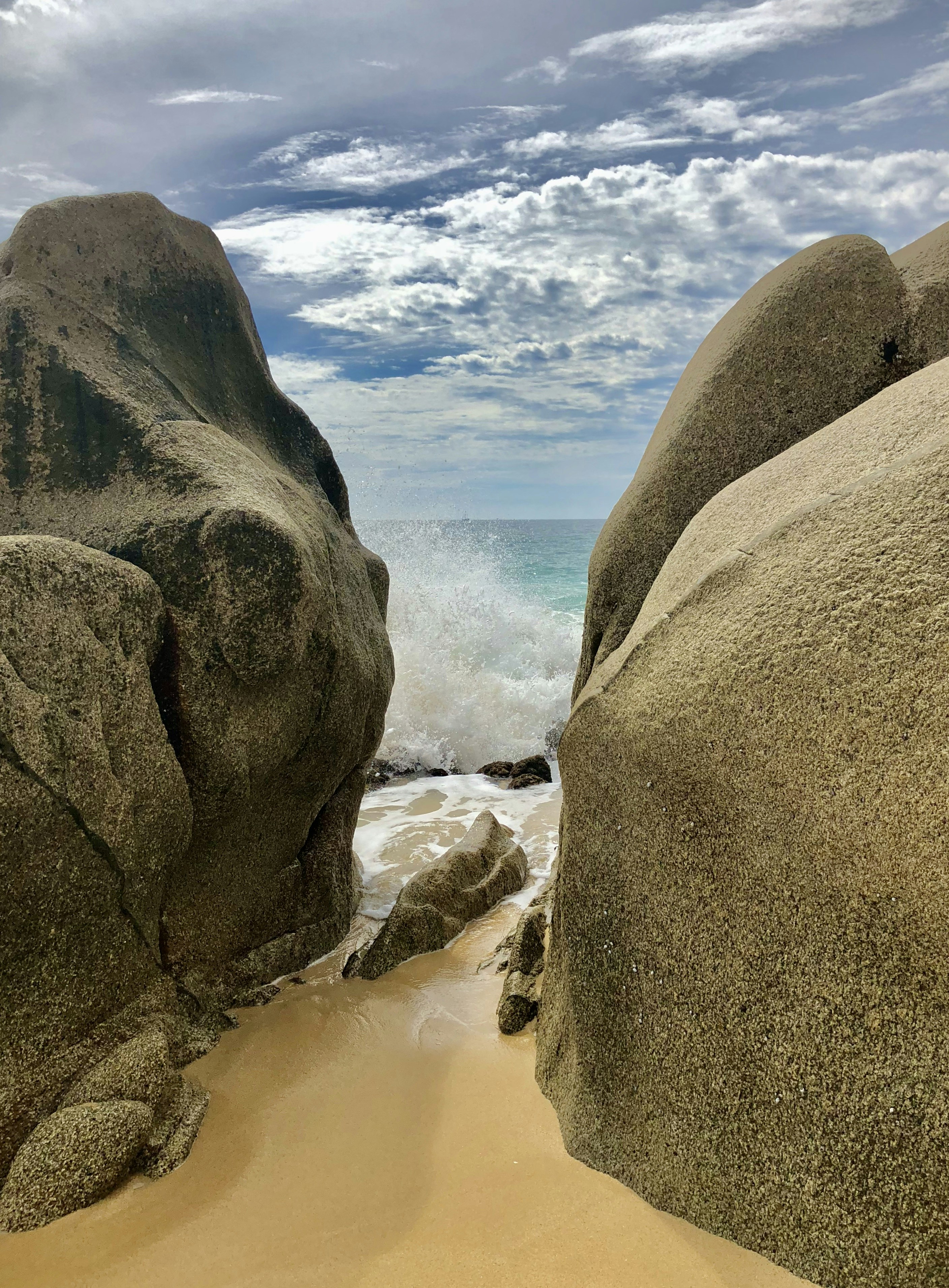 brown rocky mountain near body of water during daytime