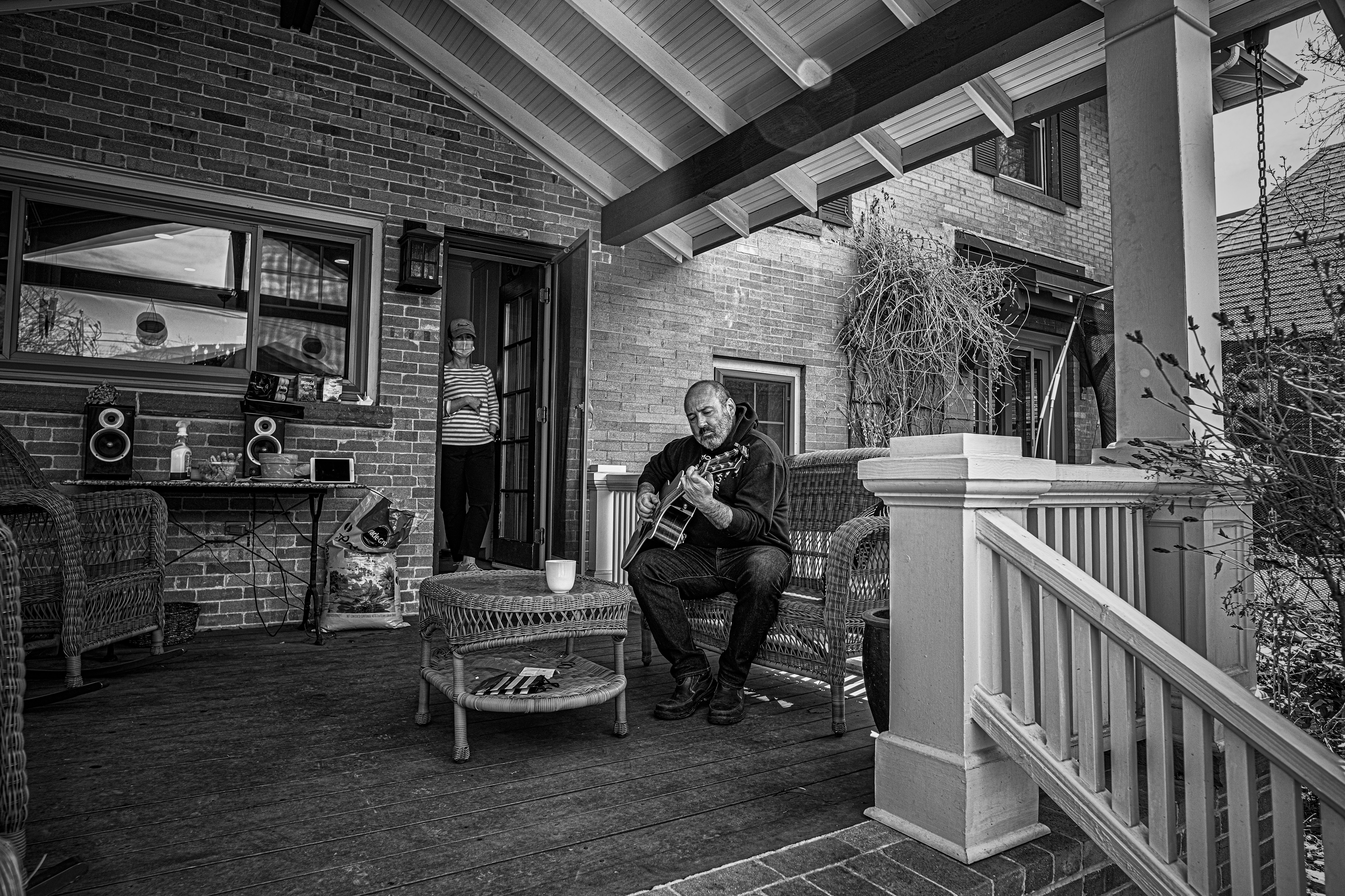 grayscale photo of man sitting on chair