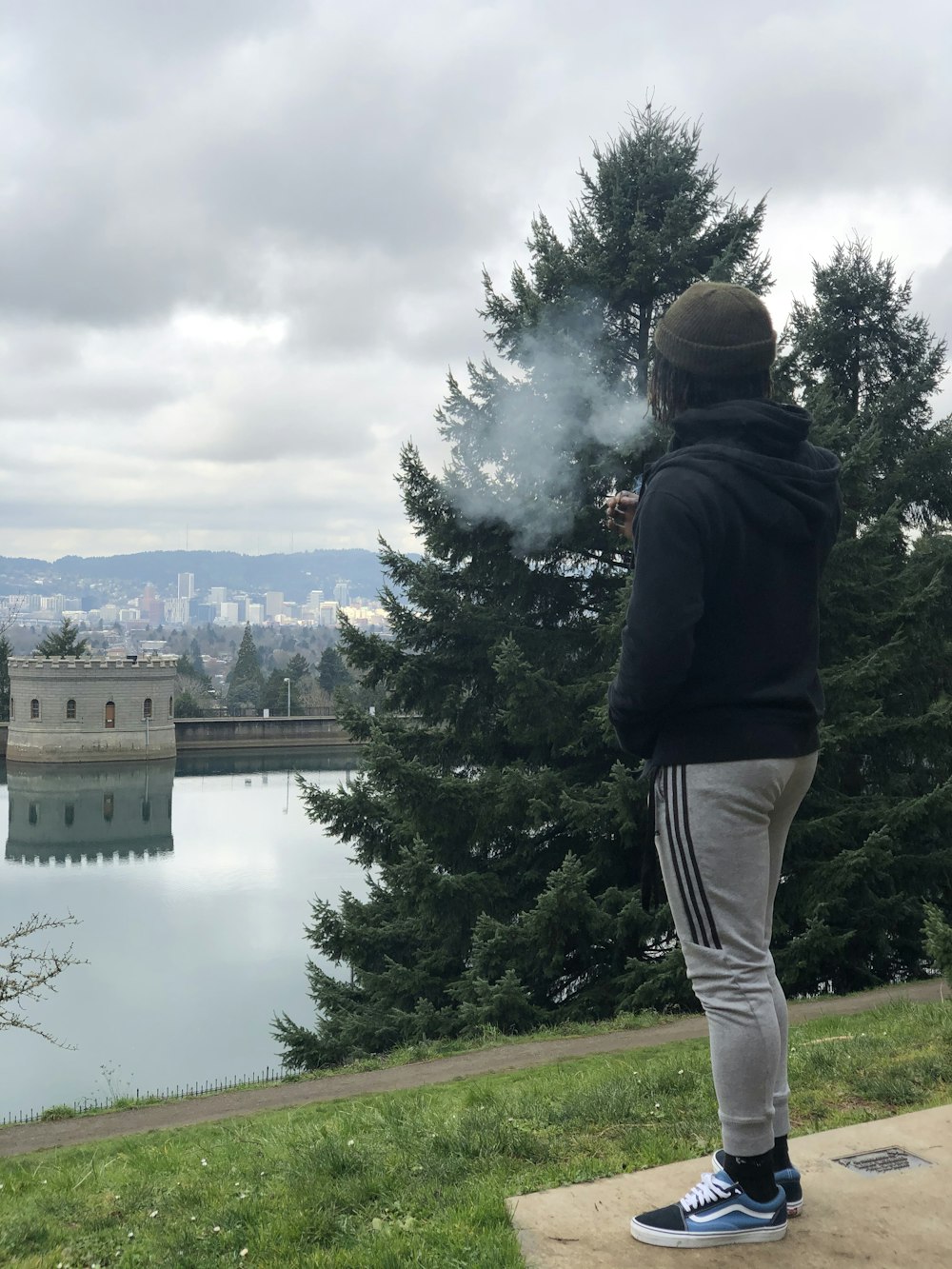 a person standing near a lake taking a picture