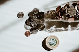 clear glass bottle with silver round coins
