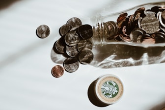 clear glass bottle with silver round coins