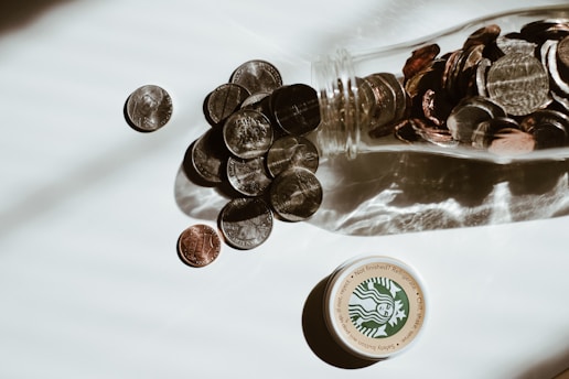 clear glass bottle with silver round coins