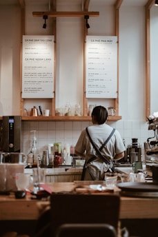 woman in gray shirt sitting on chair in front of table