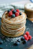 brown cupcake with red and black berries on top