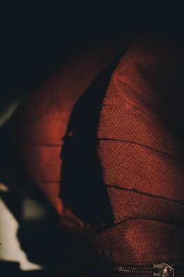 Close-up of a Lumina hoodie’s detailed stitching and fabric texture under soft natural light.