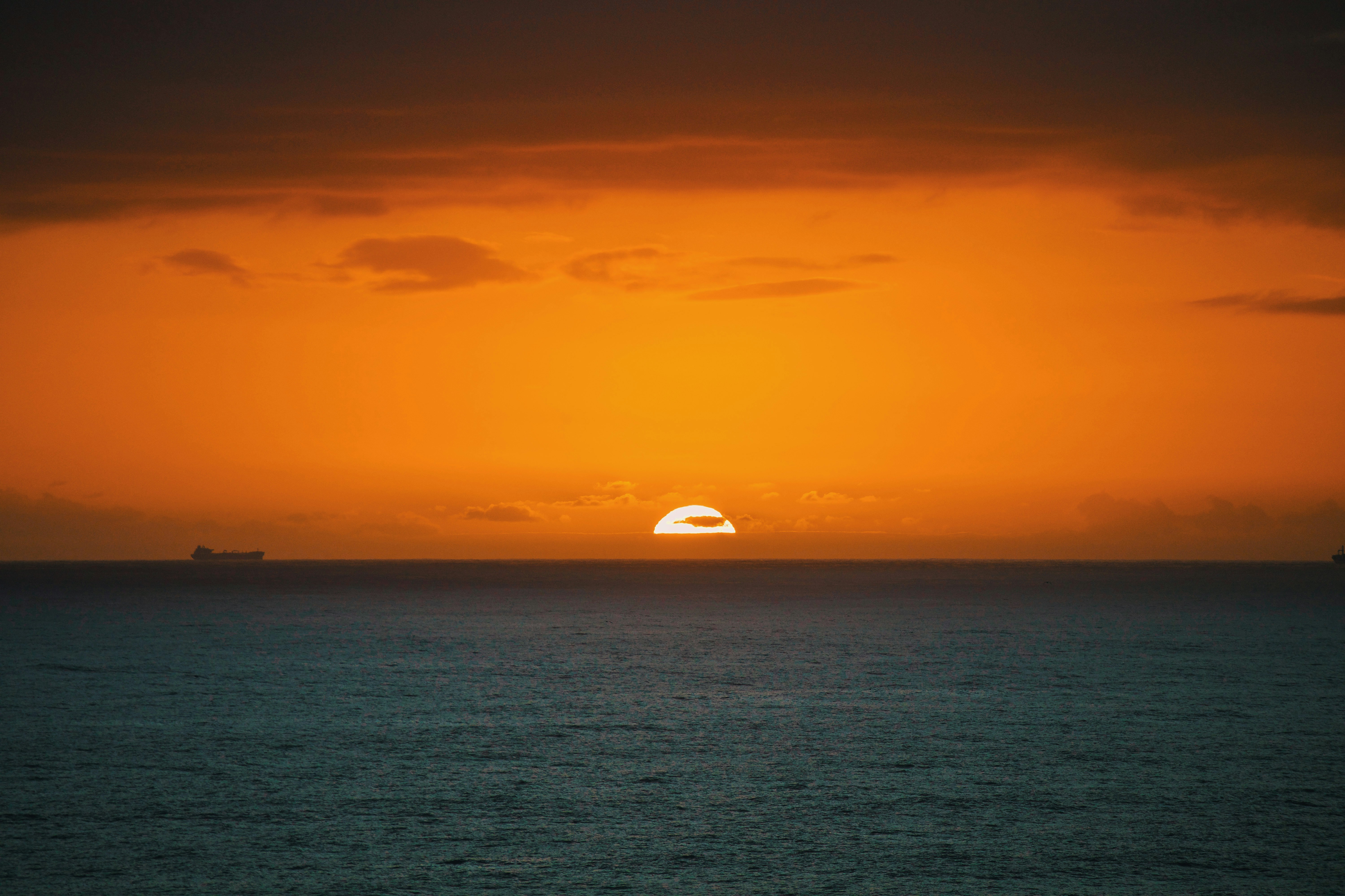black and white dome tent on blue sea under blue sky during daytime