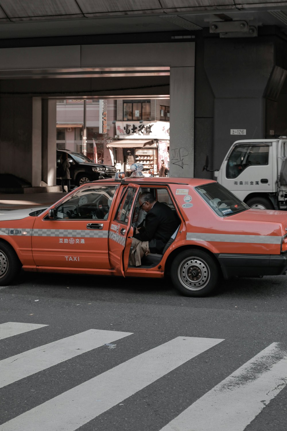 orange and black car on road during daytime