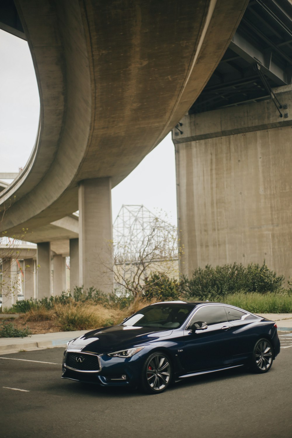 black coupe parked near brown concrete building during daytime