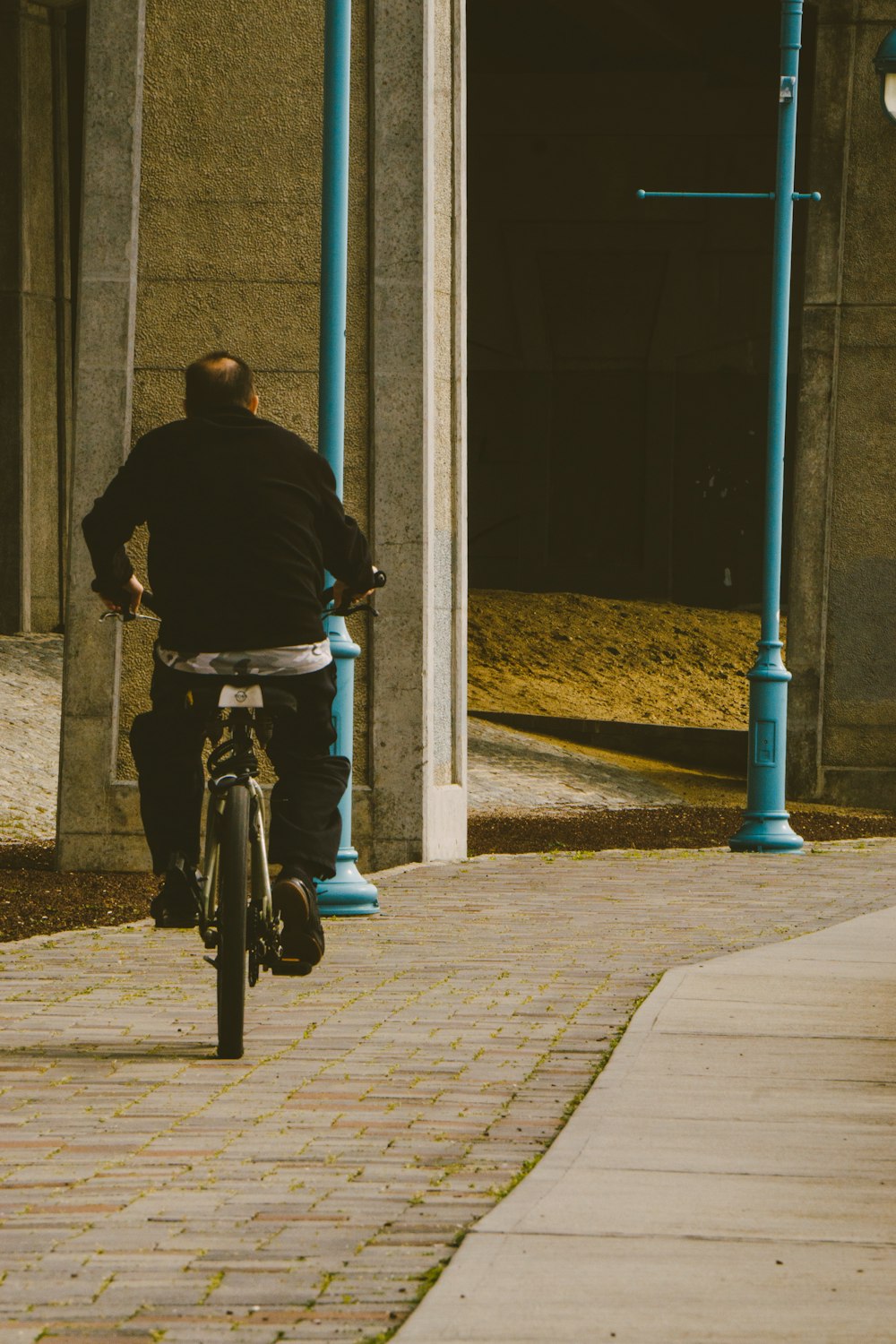 man in purple jacket riding bicycle during daytime