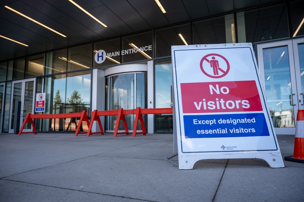 a no visitors sign in front of a building