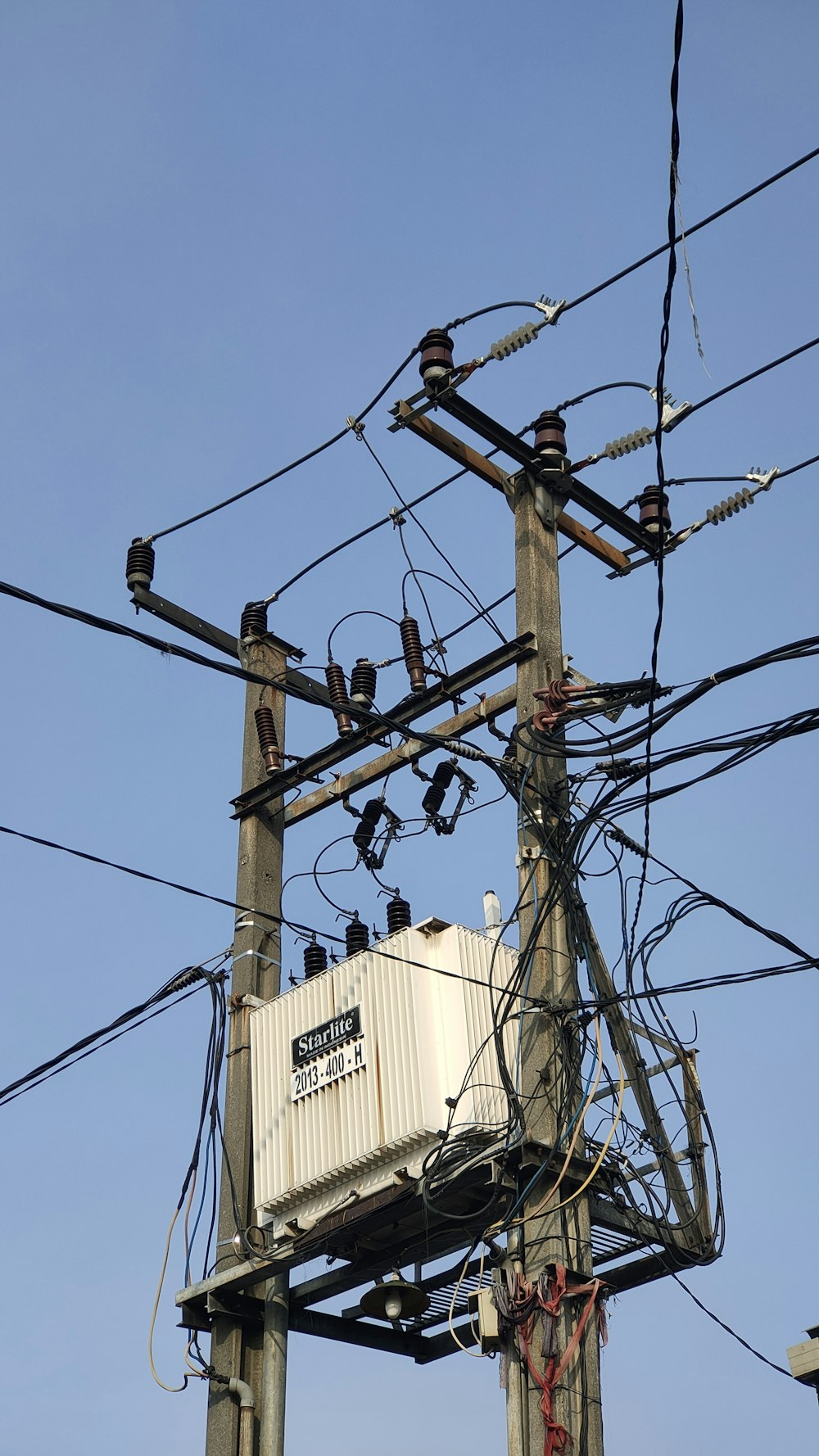 brown electric post with wires