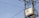 A utility pole with numerous electrical wires is visible, featuring a large transformer labeled 'Starlite' mounted on a metal structure. The sky in the background is clear and blue.