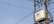A utility pole with numerous electrical wires is visible, featuring a large transformer labeled 'Starlite' mounted on a metal structure. The sky in the background is clear and blue.