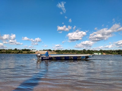 blue and white boat on sea under blue sky and white clouds during daytime pretty google meet background