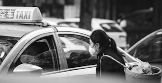 grayscale photo of woman in black jacket and black sunglasses
