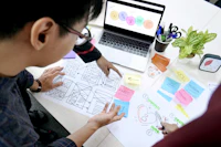 A designer planning user experience wireframes on paper