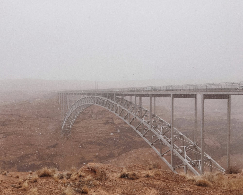 white metal bridge over the sea