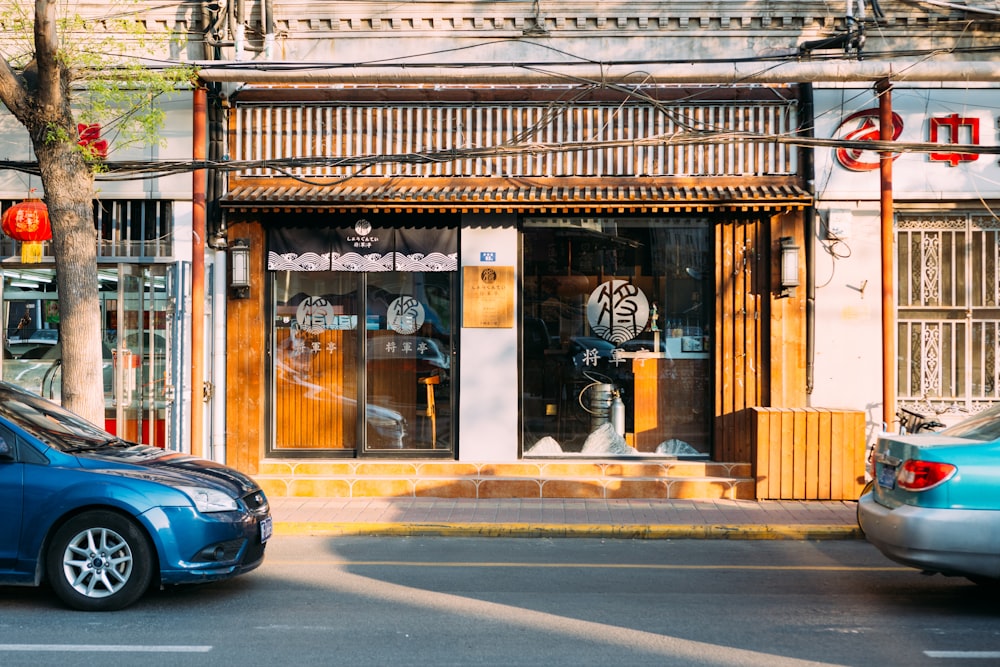 blue car parked beside store