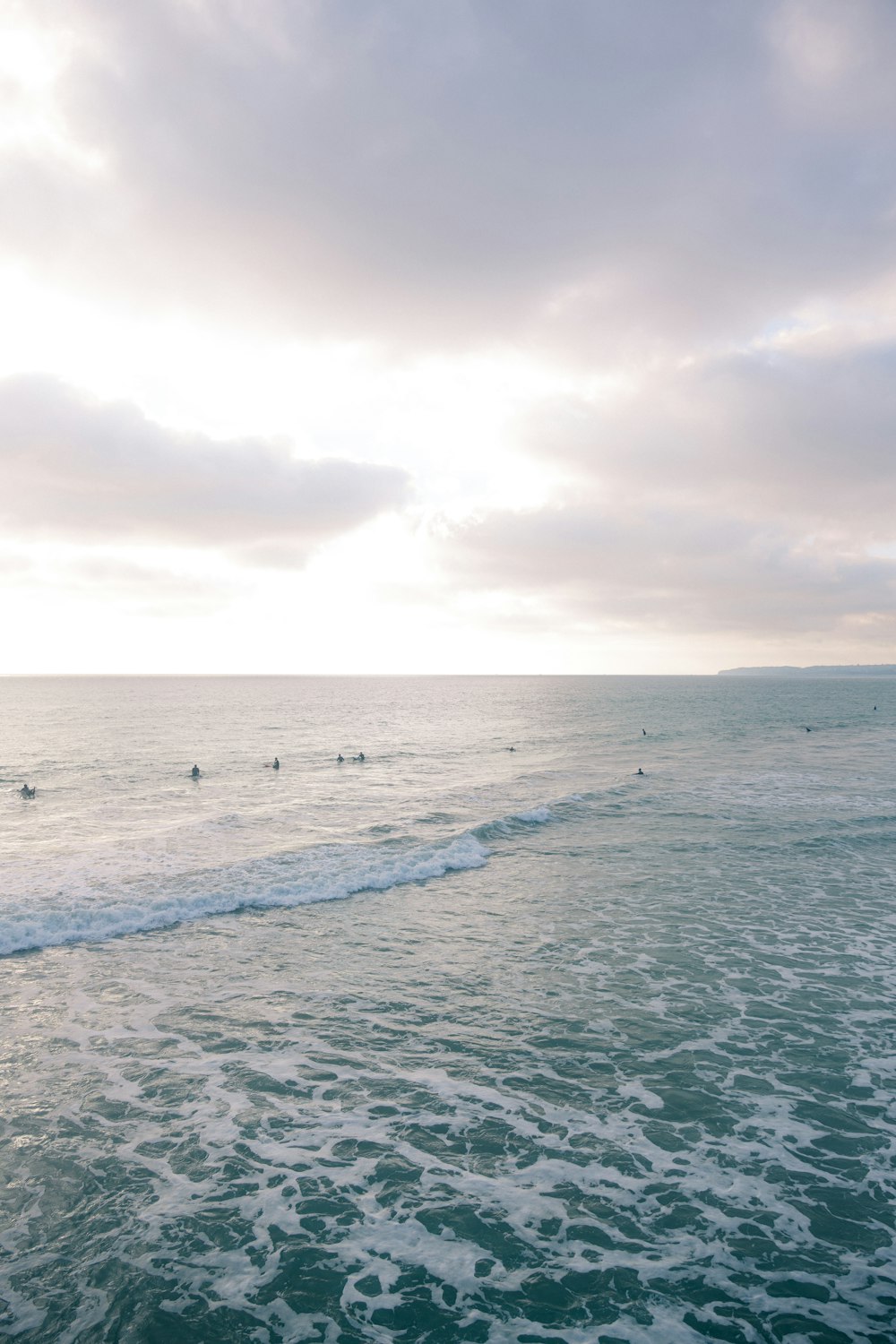 ocean waves under cloudy sky during daytime