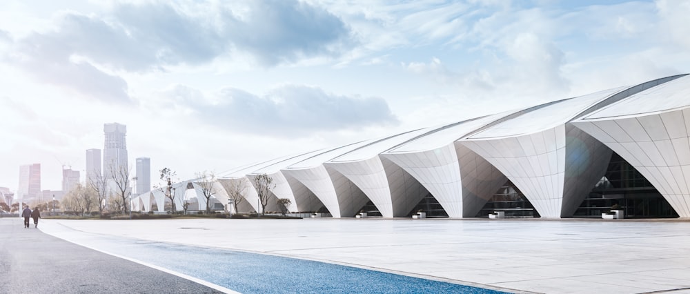 white concrete building under white clouds during daytime