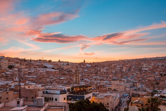 city with high rise buildings under blue sky during daytime in Fez Morocco