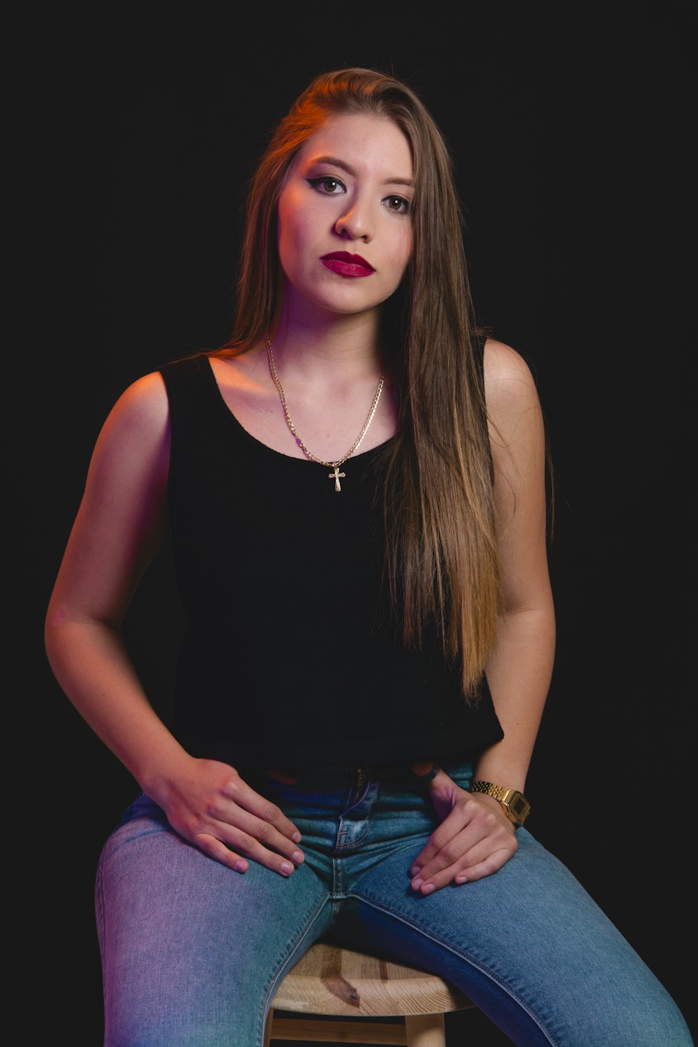 woman in black tank top and blue denim jeans