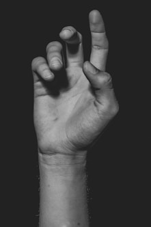 grayscale photo of persons hand
