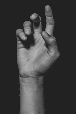 grayscale photo of persons hand