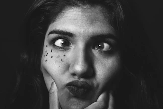 grayscale photo of womans face