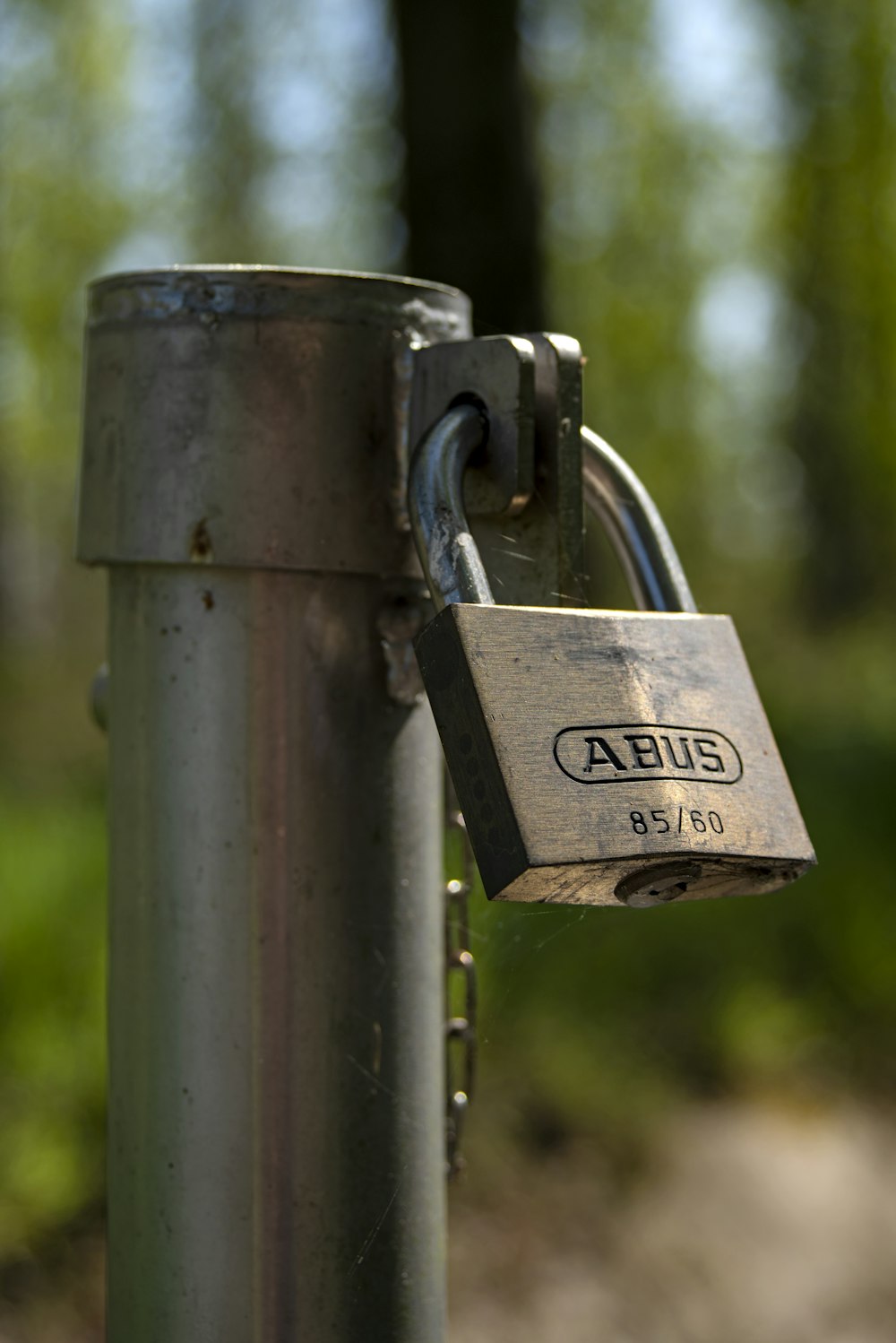 padlock on gray steel fence