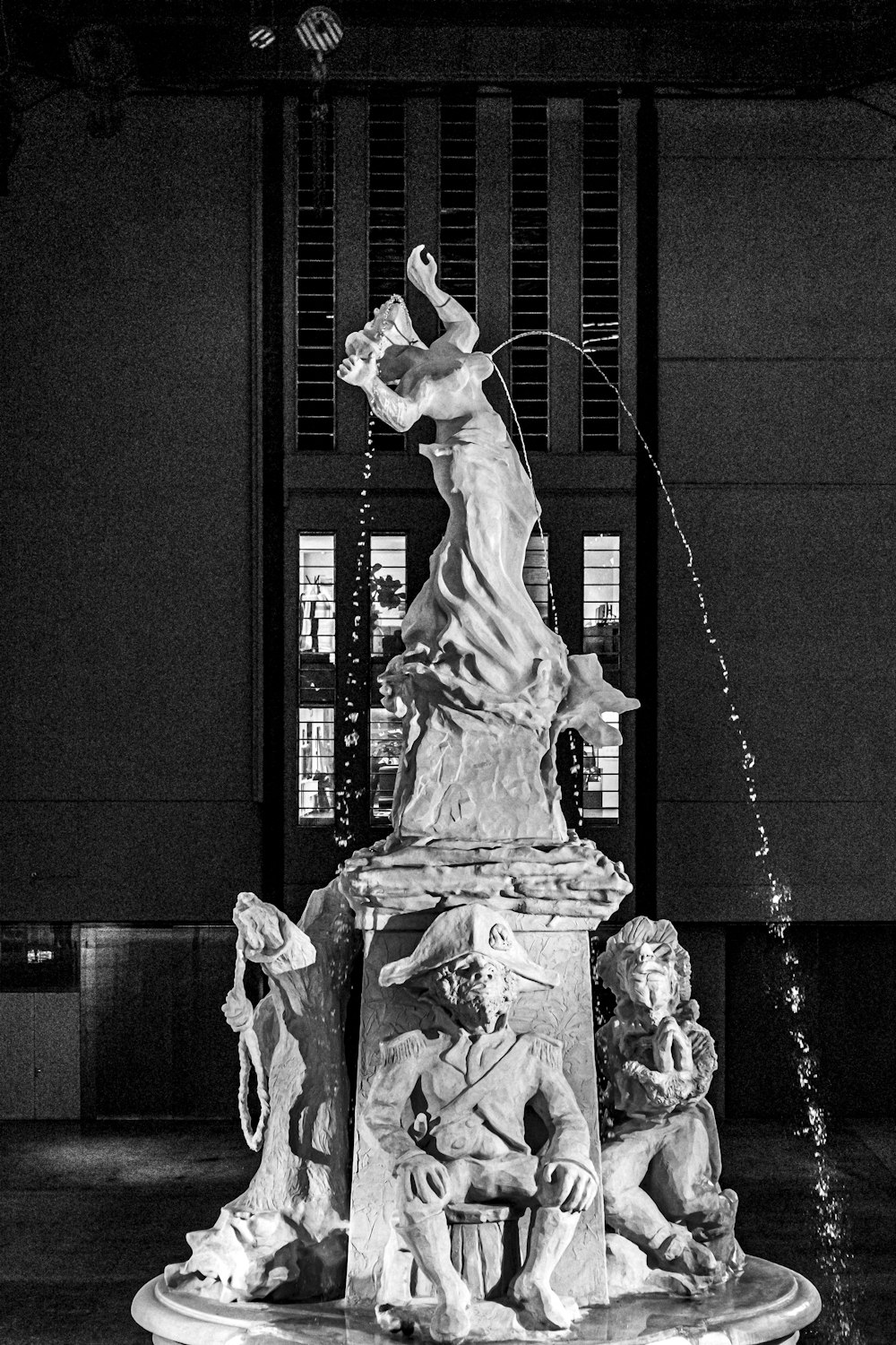 grayscale photo of woman dancing fountain