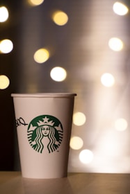 white and green starbucks disposable cup