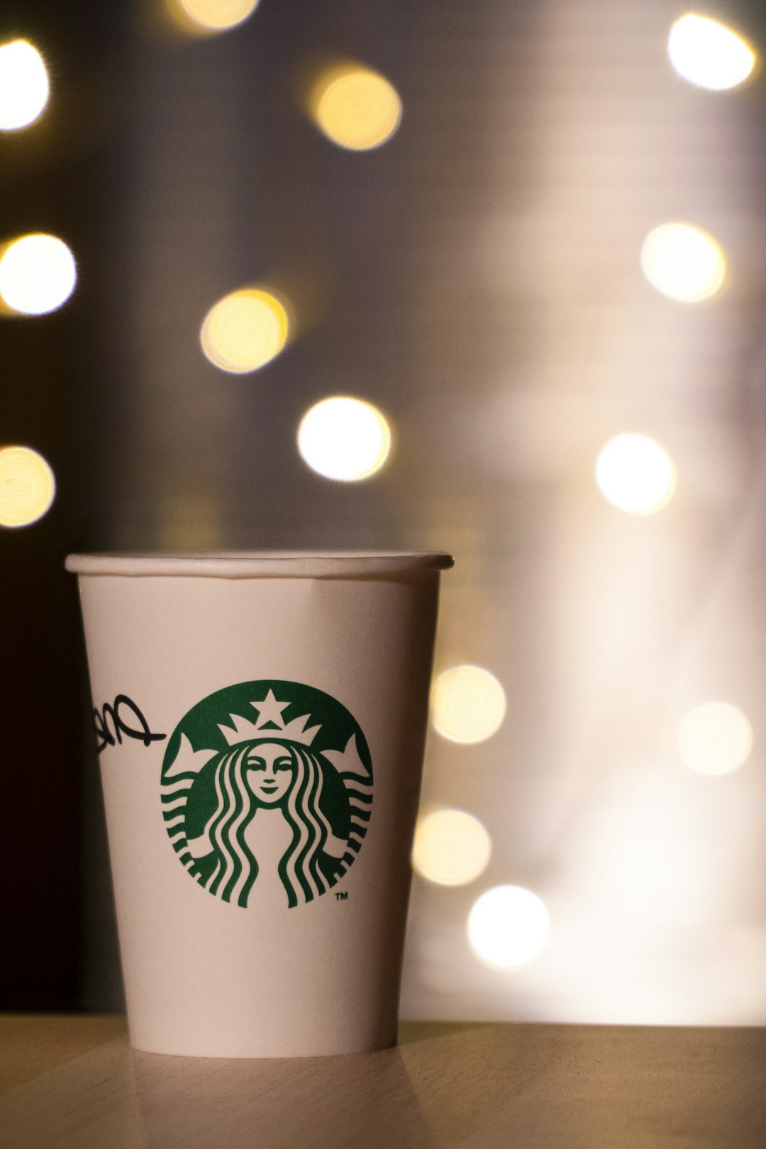 white and green starbucks disposable cup