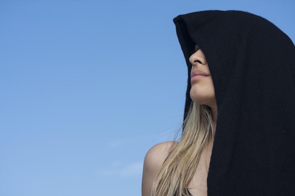 woman in black tank top under blue sky during daytime