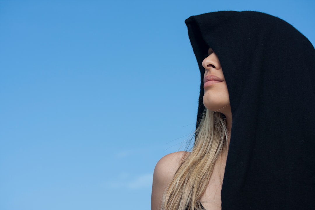 woman in black tank top under blue sky during daytime