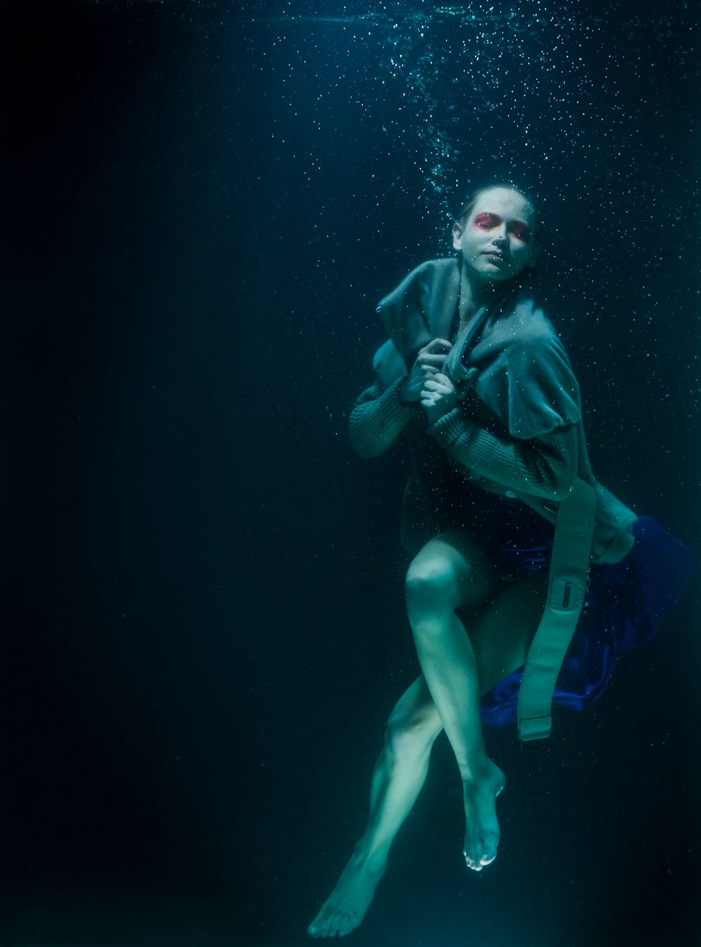 woman in black leather jacket and black shorts under water