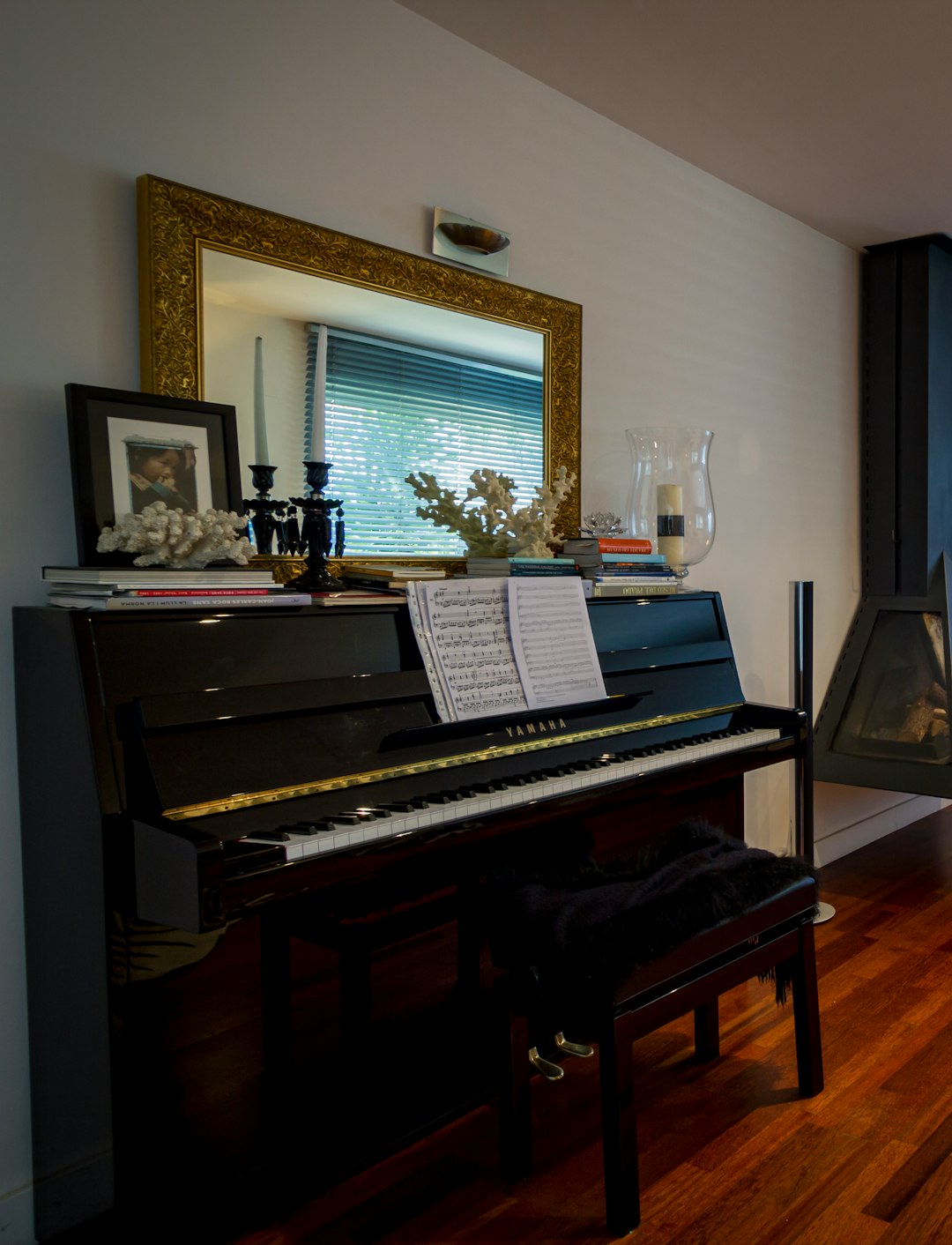 black upright piano near brown wooden framed mirror