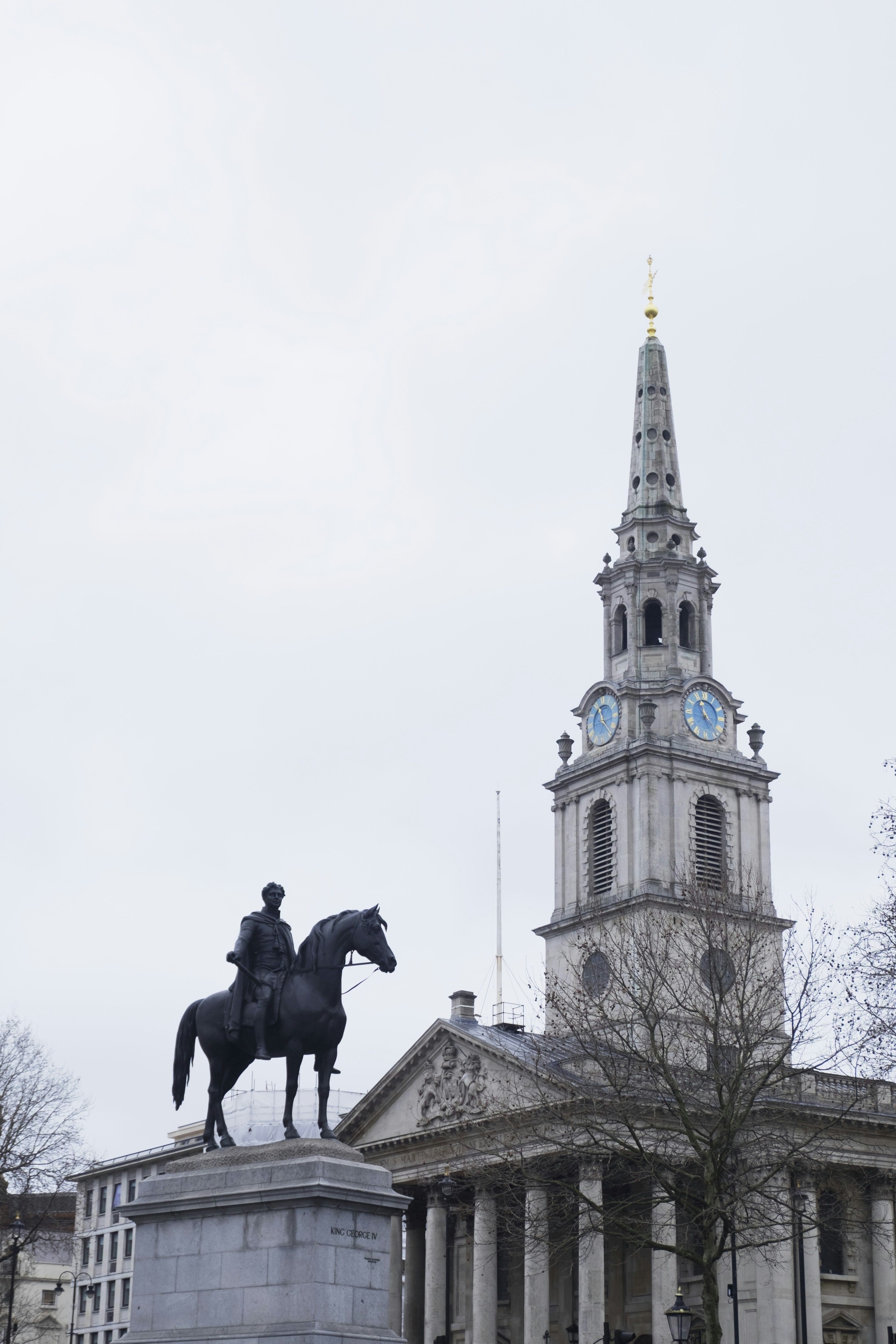 black horse statue near brown concrete building during daytime
