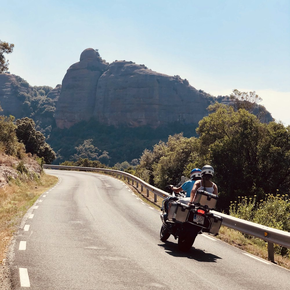 man riding motorcycle on road during daytime