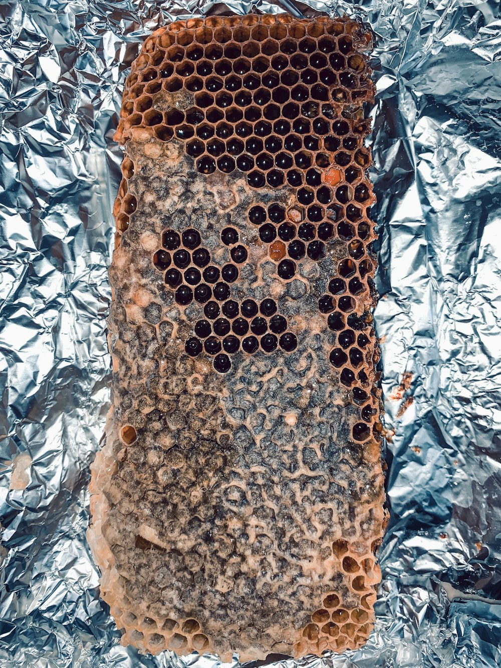 a beehive with a face drawn on it