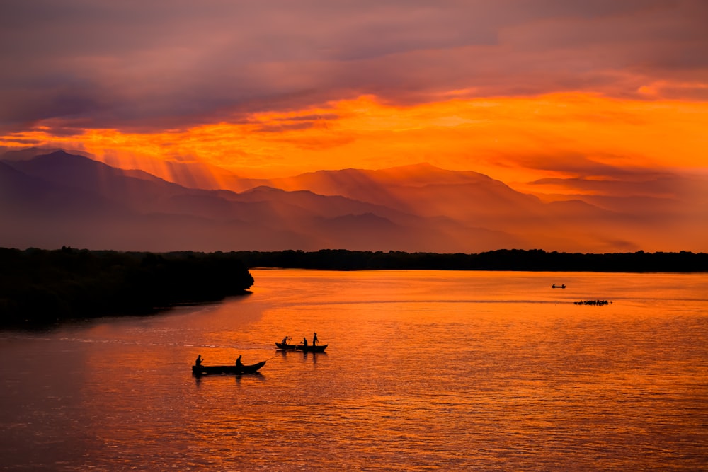 a couple of boats floating on top of a lake