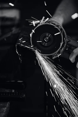 Close-up of a high-precision grinding machine in operation with sparks flying.