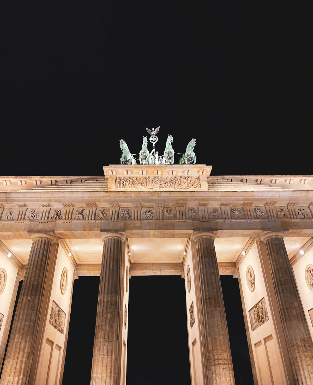 Berlin Brandenburg Gate illuminated at night with clear sky