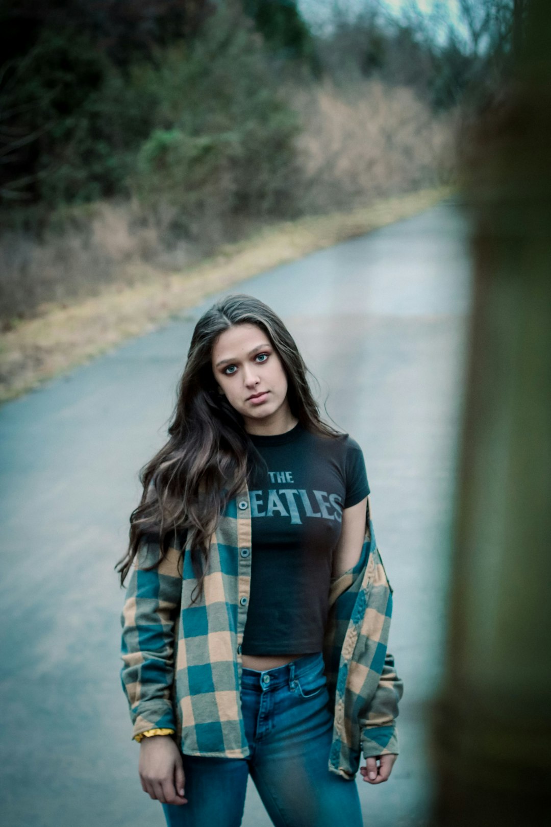 woman in black and blue crew neck t-shirt standing on road during daytime