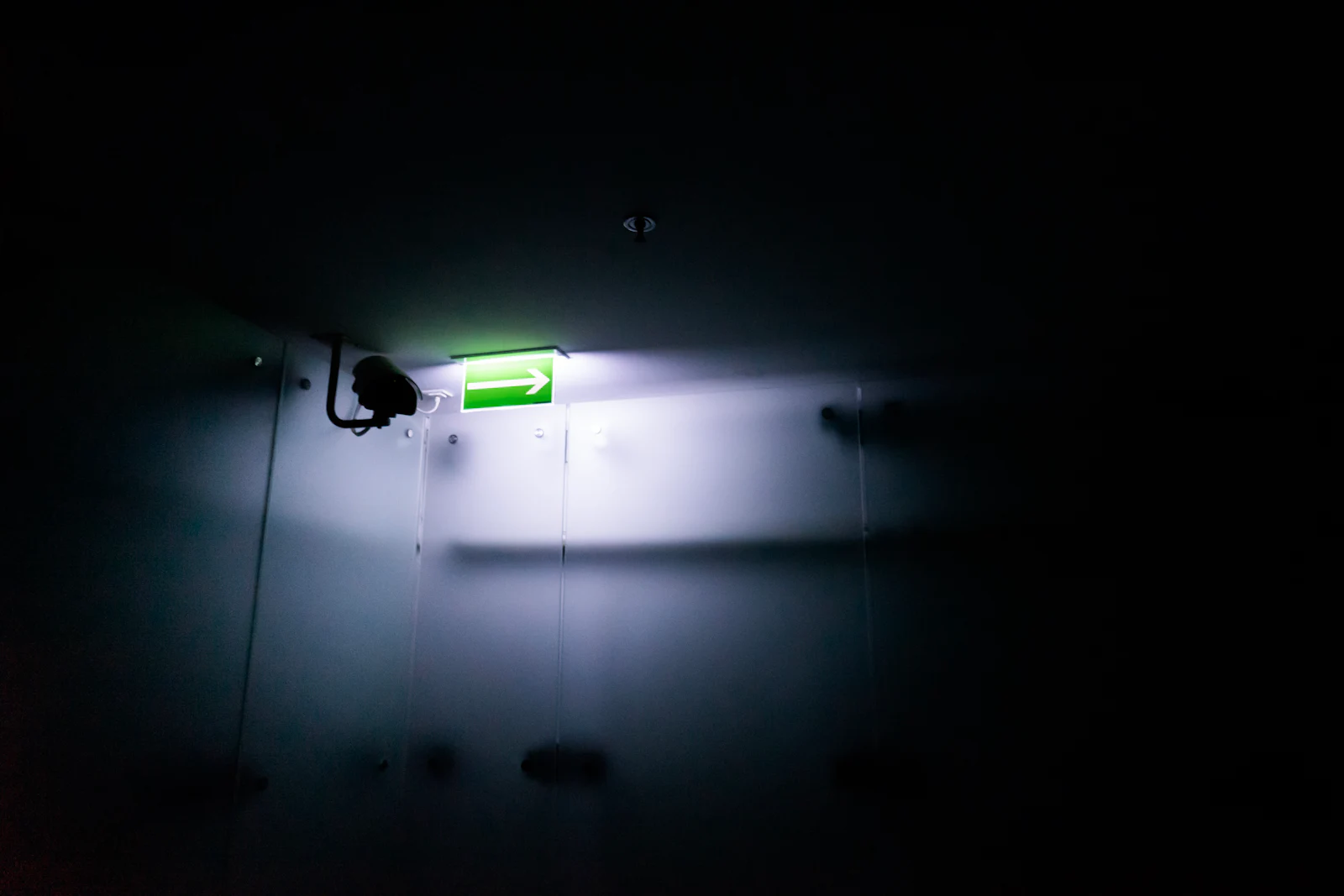 A bare fluorescent tube burning in an empty room.