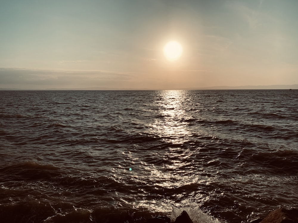 body of water during sunset