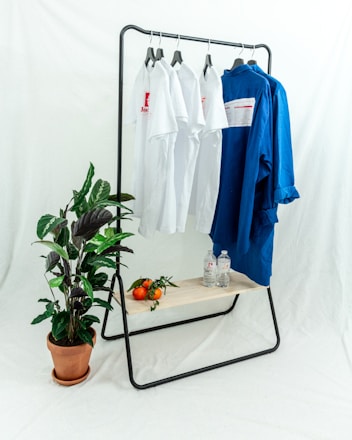 blue polo shirt on white clothes hanger