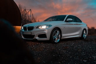 a white car parked on a gravel road