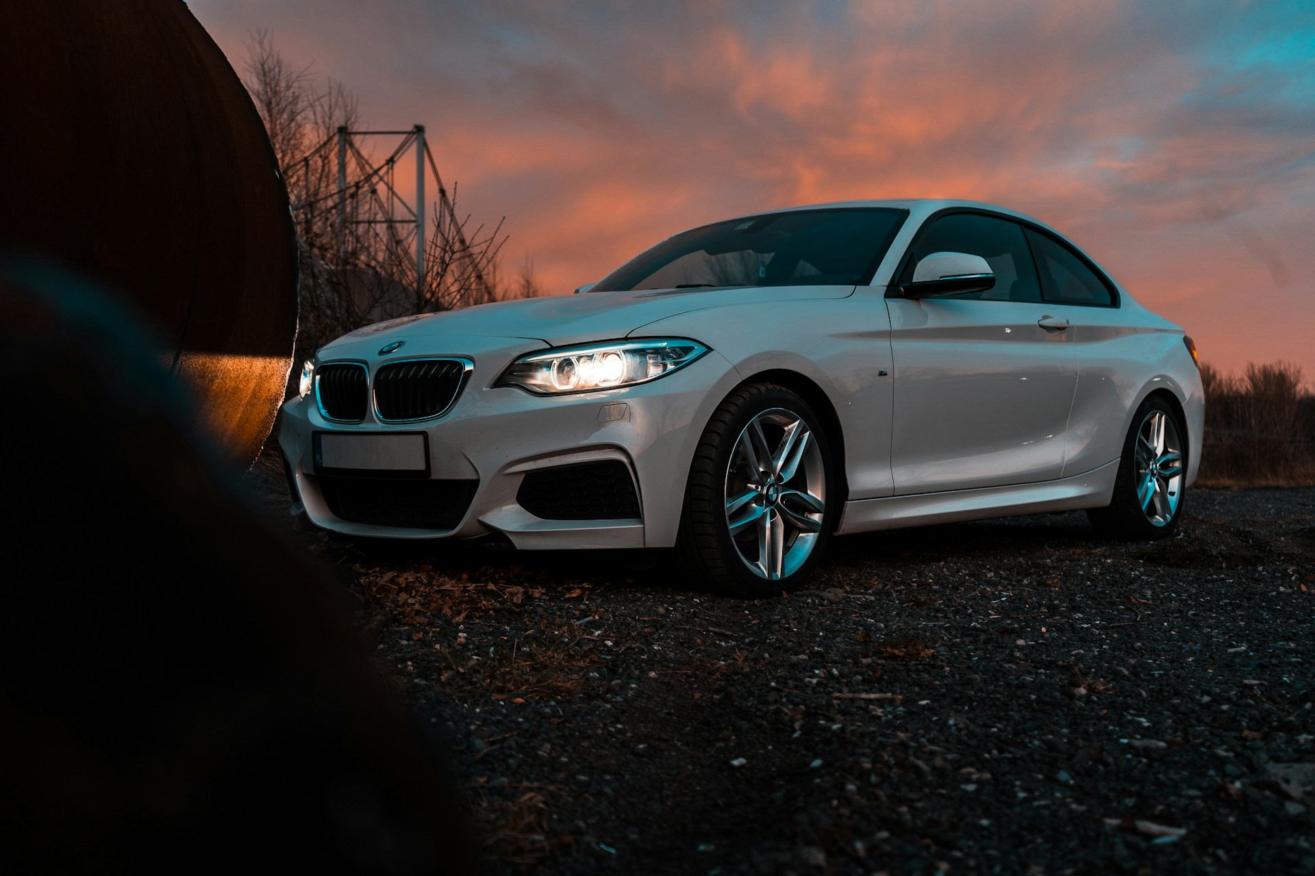 a white car parked on a gravel road