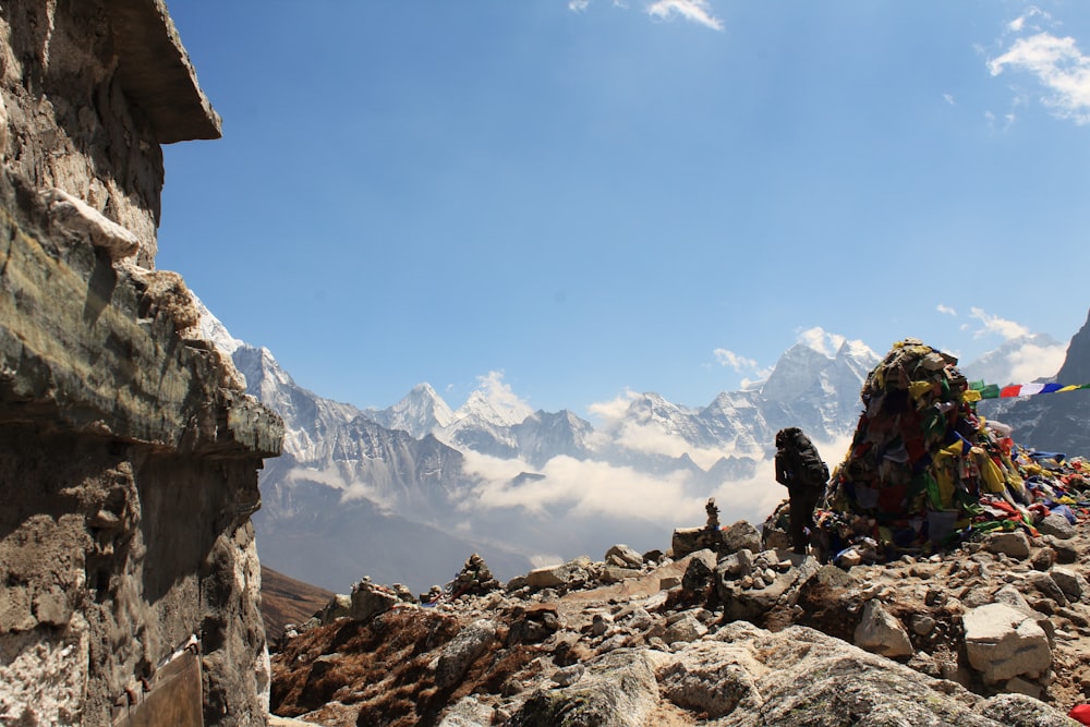 person sitting on rock formation during daytime